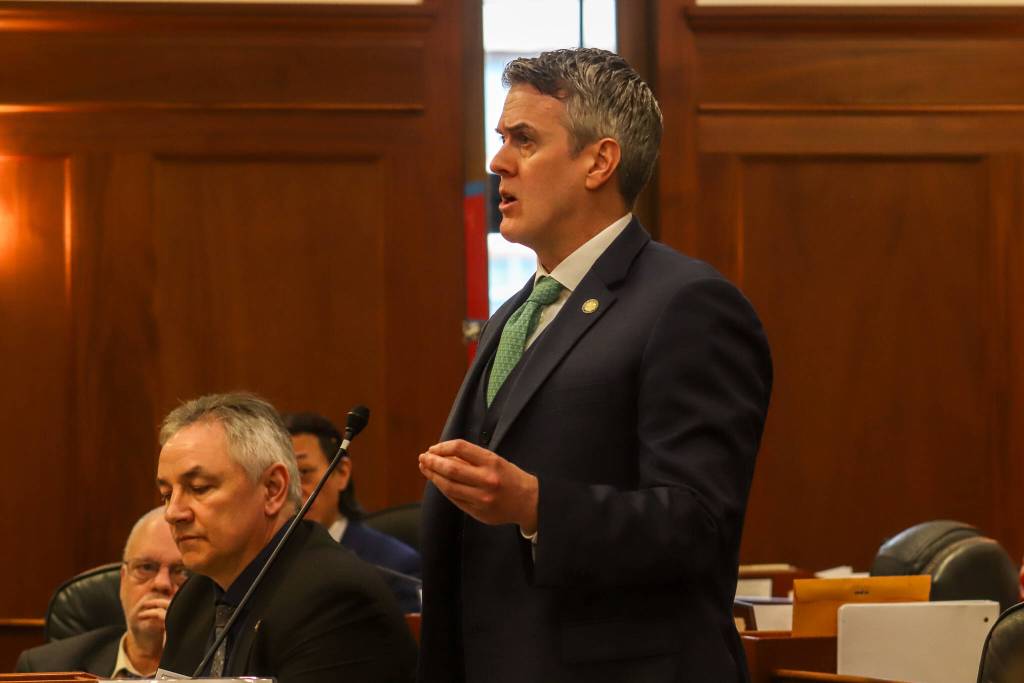 Rep. Andrew Gray (D-Anchorage) asks U.S. Sen. Dan Sullivan (R-Alaska) a question after his speech to the Alaska Legislature on Thursday, March 20, 2025. (Jasz Garrett / Juneau Empire)