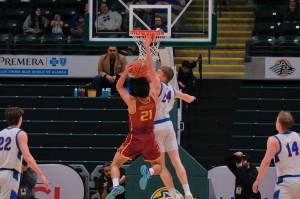 Sitka junior Trey Johnson (24) challenges a shot by Mt. Edgecumbe senior Richard Didrickson Jr (21) during the Wolves 64-62 semifinal win over the Braves on Thursday in the 2025 ASAA March Madness Alaska 3A/4A Basketball State Championships at Anchorages Alaska Airlines Center. (Klas Stolpe / Juneau Empire)