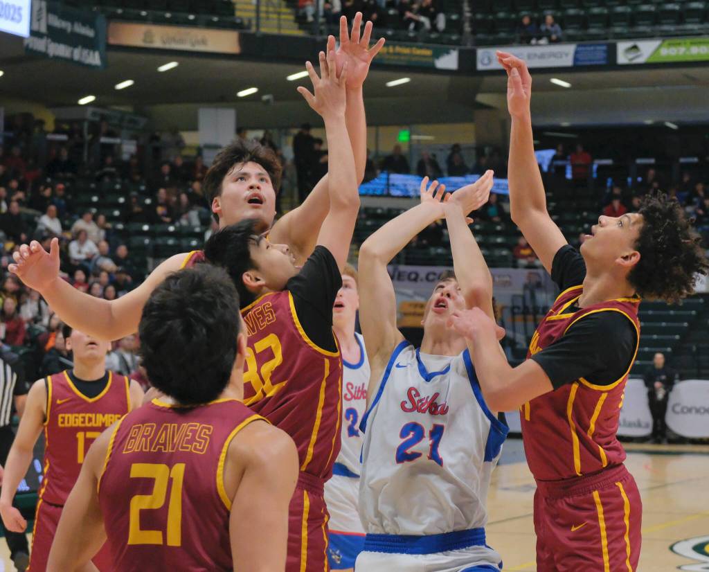 Sitka and Mt. Edgecumbe players watch as a shot rolls off the rim during the Wolves 64-62 semifinal win over the Braves on Thursday in the 2025 ASAA March Madness Alaska 3A/4A Basketball State Championships at Anchorages Alaska Airlines Center. (Klas Stolpe / Juneau Empire)