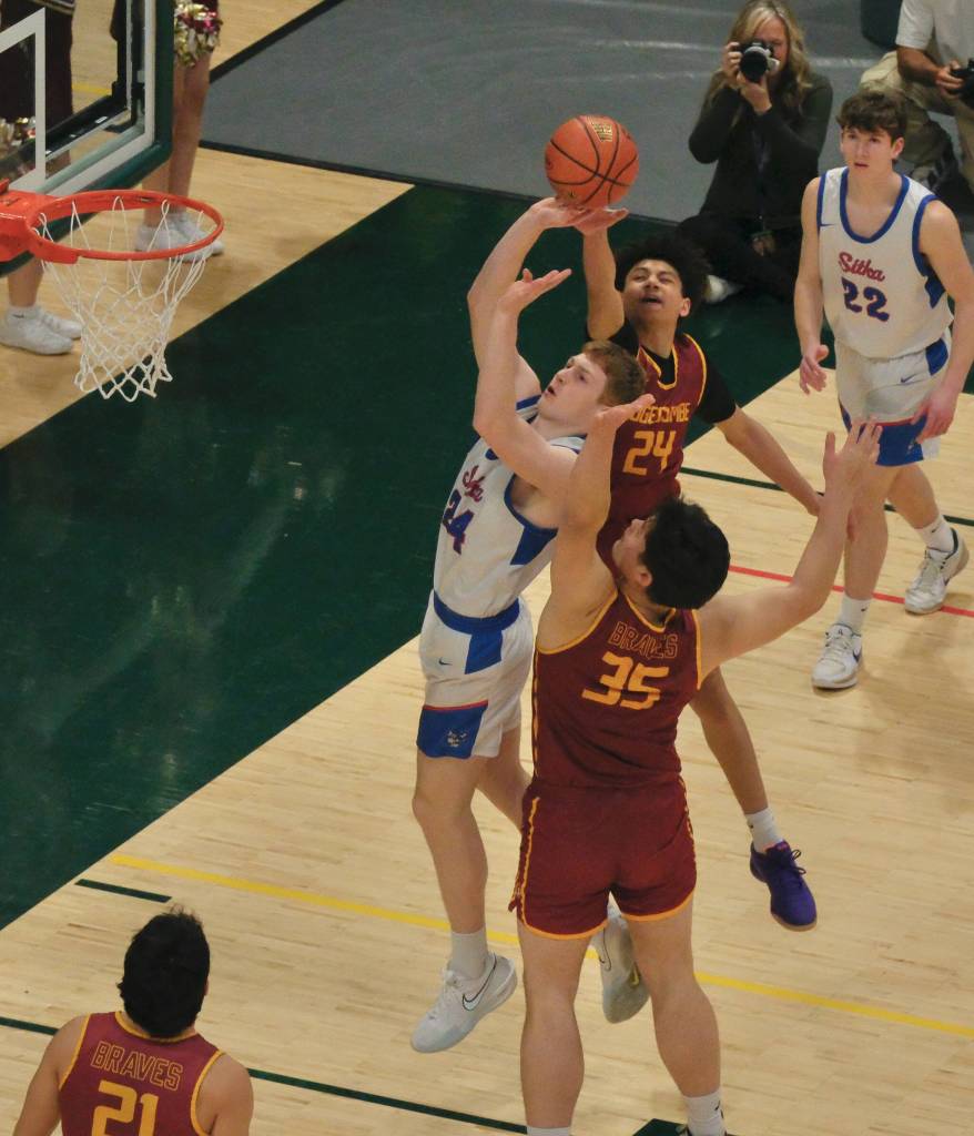 Mt. Edgecumbes Xavier Gundersen (24) blocks a shot by Sitkas Trey Johnson (24) during the Braves 64-62 semifinal loss to the Wolves on Thursday in the 2025 ASAA March Madness Alaska 3A/4A Basketball State Championships at Anchorages Alaska Airlines Center. (Klas Stolpe / Juneau Empire)