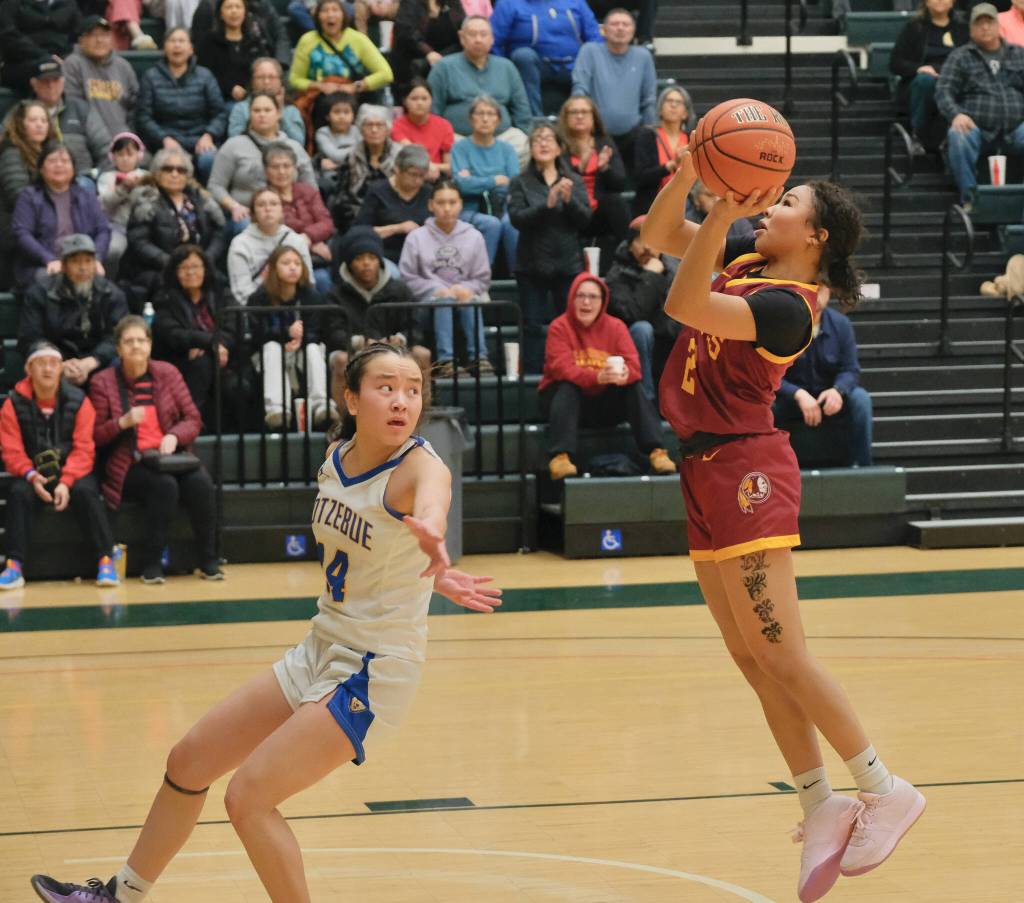 Mt. Edgecumbes Tahira Akaran (2) floats a shot over Kotzebues McKenzie Swanson (14) Thursday in the Braves 49-42 consolation bracket win over the Buccaneers during the 2025 ASAA March Madness Alaska 3A/4A Basketball State Championships at Anchorages Alaska Airlines Center. (Klas Stolpe / Juneau Empire)