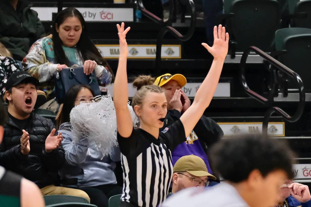 Zosha Krupa signals a three-point shot during a game at the 2025 ASAA March Madness Alaska 1A/2A Basketball State Championships at Anchorages Alaska Airlines Center. (Klas Stolpe / Juneau Empire)