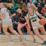 Juneau-Douglas High School: Yadaa.at Kalé freshman Sadie Tuckwood (13) defends Colony senior Aria Smith (32) during the Crimson Bears 56-34 loss to the Knights in a Friday 4A girls semifinal at the 2025 ASAA March Madness Alaska 3A/4A Basketball State Championships at Anchorages Alaska Airlines Center. (Klas Stolpe / Juneau Empire)