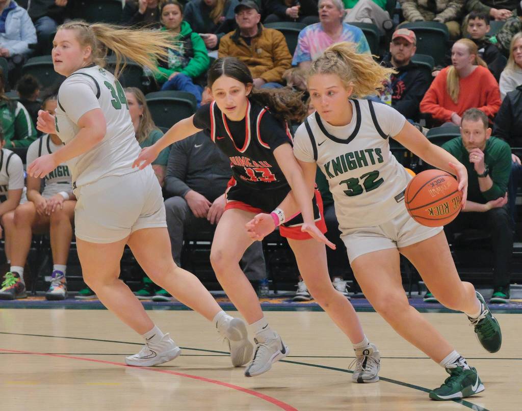 Juneau-Douglas High School: Yadaa.at Kalé freshman Sadie Tuckwood (13) defends Colony senior Aria Smith (32) during the Crimson Bears 56-34 loss to the Knights in a Friday 4A girls semifinal at the 2025 ASAA March Madness Alaska 3A/4A Basketball State Championships at Anchorages Alaska Airlines Center. (Klas Stolpe / Juneau Empire)