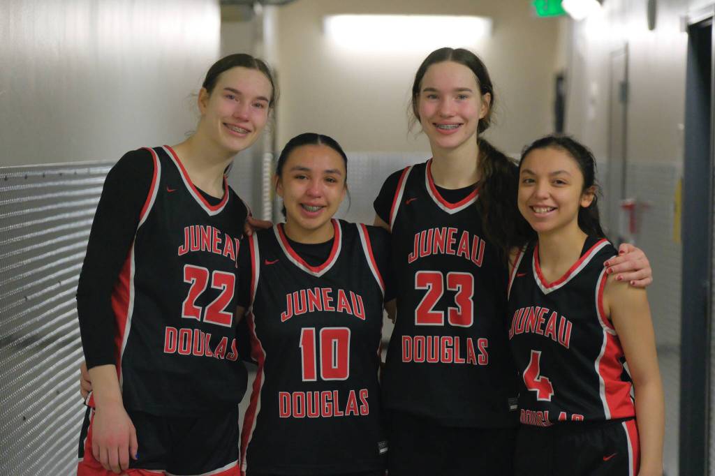JDHS seniors Kerra Baxter (22), Addison Wilson (10), Cailynn Baxter (23) and Mary Johnson (4) pose Saturday after their final game in the 2025 ASAA March Madness Alaska 4A Basketball State Championships in Anchorages Alaska Airlines Center. (Klas Stolpe / Juneau Empire)