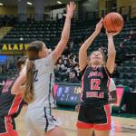 JDHS sophomore Bergen Erickson (12) shoots against Mountain City Christian Academy during the Crimson Bears 57-37 loss to the Lions in the 3rd/5th-place game Saturday at 2025 ASAA March Madness Alaska 4A Basketball State Championships in Anchorages Alaska Airlines Center. (Klas Stolpe / Juneau Empire)