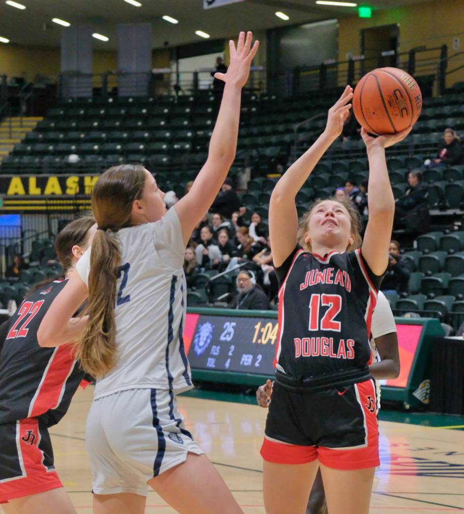JDHS sophomore Bergen Erickson (12) shoots against Mountain City Christian Academy during the Crimson Bears 57-37 loss to the Lions in the 3rd/5th-place game Saturday at 2025 ASAA March Madness Alaska 4A Basketball State Championships in Anchorages Alaska Airlines Center. (Klas Stolpe / Juneau Empire)