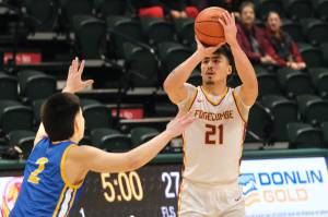 Mt. Edgecumbes Richard Didrickson Jr. (21) shoots from past the arc over Barrows Ethan Goodwin (2) during the Braves 81-73 win over the Whalers in the 3A boys 3rd/5th-place game Saturday at 2025 ASAA March Madness Alaska 3A/4A Basketball State Championships in Anchorages Alaska Airlines Center. (Klas Stolpe / Juneau Empire)