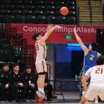 Mt. Edgecumbes Kaden Herrmann (13) scores over Barrows Ethan Goodwin (2) as Whalers coach Wyman Ipalook instructs his team during the Braves 81-73 win over the Whalers in the 3A boys 3rd/5th-place game Saturday at 2025 ASAA March Madness Alaska 3A/4A Basketball State Championships in Anchorages Alaska Airlines Center. (Klas Stolpe / Juneau Empire)