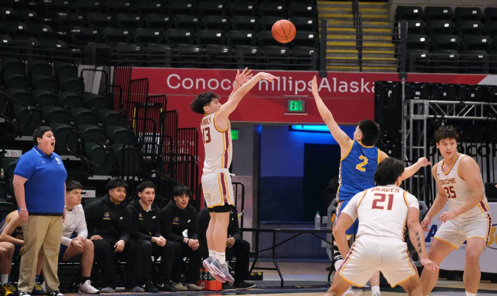 Mt. Edgecumbes Kaden Herrmann (13) scores over Barrows Ethan Goodwin (2) as Whalers coach Wyman Ipalook instructs his team during the Braves 81-73 win over the Whalers in the 3A boys 3rd/5th-place game Saturday at 2025 ASAA March Madness Alaska 3A/4A Basketball State Championships in Anchorages Alaska Airlines Center. (Klas Stolpe / Juneau Empire)