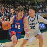 Sitka senior Bryce Compagno-Calhoun (22) drives against Nomes Kevin Ongtowasruk (32) during the Wolves 62-43 loss to the Nanooks on Saturday in the 3A championship game of the 2025 ASAA March Madness Alaska 3A Basketball State Championships in Anchorages Alaska Airlines Center. (Klas Stolpe / Juneau Empire)