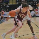 Ketchikan senior Marcus Stockhausen (34) drives to the basket under pressure by East Anchorage senior Deng Deng during the Kings 43-25 loss to the Thunderbirds on Saturday in the 4A championship game of the 2025 ASAA March Madness Alaska 4A Basketball State Championships in Anchorages Alaska Airlines Center. (Klas Stolpe / Juneau Empire)