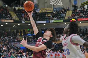 Ketchikan senior Jonathan Scoblic shoots under pressure from East Anchorage senior Muhammed Sabally (23) during the Kings 43-25 loss to the Thunderbirds on Saturday in the 4A championship game of the 2025 ASAA March Madness Alaska 4A Basketball State Championships in Anchorages Alaska Airlines Center. (Klas Stolpe / Juneau Empire)