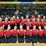 The Juneau-Douglas High School: Yadaa.at Kalé dance team pose for a photo after their Funk routine Thursday in Anchorages Alaska Airlines Center main court. Kneeling, left to right, are seniors Shaelynn Lee, Amelia Yadao, Laura Gibb, Stella Moran, Haylee Baxter, Isabella Cadigan McAdoo, Reonna Maloney, Serena Crupi and Bristol Casperson. (Klas Stolpe / Juneau Empire)