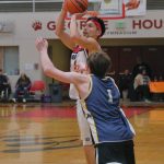 Kakes Simon Friday shoots from past the arc over Ketchikans Archie Dundas (10) in B Bracket action Sunday at the 76th Annual Juneau Lions Club Gold Medal Basketball Tournament in Juneau-Douglas High School: Yadaa.at Kalés George Houston Gymnasium. (Klas Stolpe / Juneau Empire)