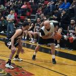 Hydaburgs Devin Edenshaw looks for a move against Hoonahs (#2) during a C bracket game Sunday at the the 76th Juneau Lions Club Gold Medal Basketball Tournament on Sunday, March 23, at Juneau-Douglas High School: Yadaa.at Kalé. (Mark Sabbatini / Juneau Empire)