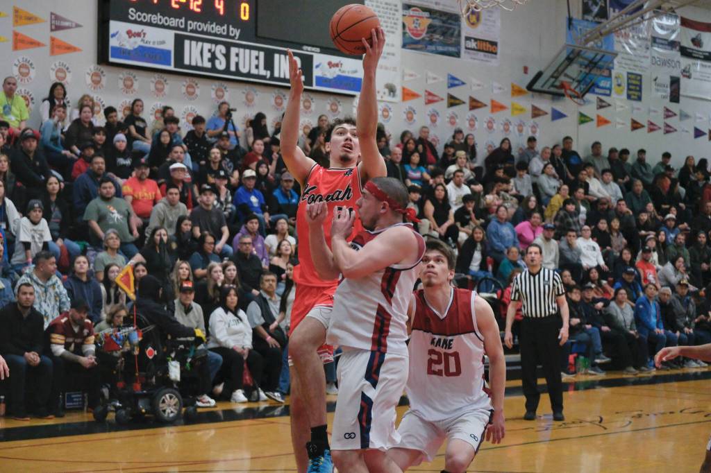 Hoonahs Orion Dybdahl shoots under pressure from Kakes Tracy Jackson and Jonah Davis (20) during Hoonahs 84-66 B Bracket win Monday at the 76th Annual Juneau Lions Club Gold Medal Basketball Tournament in Juneau-Douglas High School: Yadaa.at Kalés George Houston Gymnasium. (Klas Stolpe / Juneau Empire)