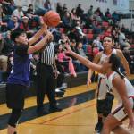 Hooper Bays Susie Long (3) shoots from past the arc over Hoonahs Antonia Fogg and Jonelle Stavland (back) in Womens Bracket play Monday at the 76th Annual Juneau Lions Club Gold Medal Basketball Tournament in Juneau-Douglas High School: Yadaa.at Kalés George Houston Gymnasium. (Klas Stolpe / Juneau Empire)