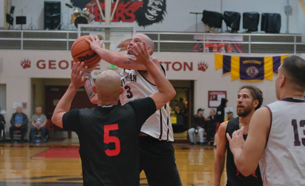 Klukwans Jacob Hotch (3) shoots over Hydaburgs Devin Edenshaw (5) during C Bracket action Monday at the 76th Annual Juneau Lions Club Gold Medal Basketball Tournament in Juneau-Douglas High School: Yadaa.at Kalés George Houston Gymnasium. (Klas Stolpe / Juneau Empire)