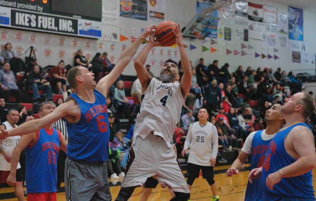 Angoons Marti Fred (4) has his shot challenged by Sitkas Cliff Richter (6) as Sitkas Ray Kitka (11), Efren Arce (4) and Jeremy Plank (44) during Sitkas 63-36 Masters Bracket win Monday at the 76th Annual Juneau Lions Club Gold Medal Basketball Tournament in Juneau-Douglas High School: Yadaa.at Kalés George Houston Gymnasium. (Klas Stolpe / Juneau Empire)