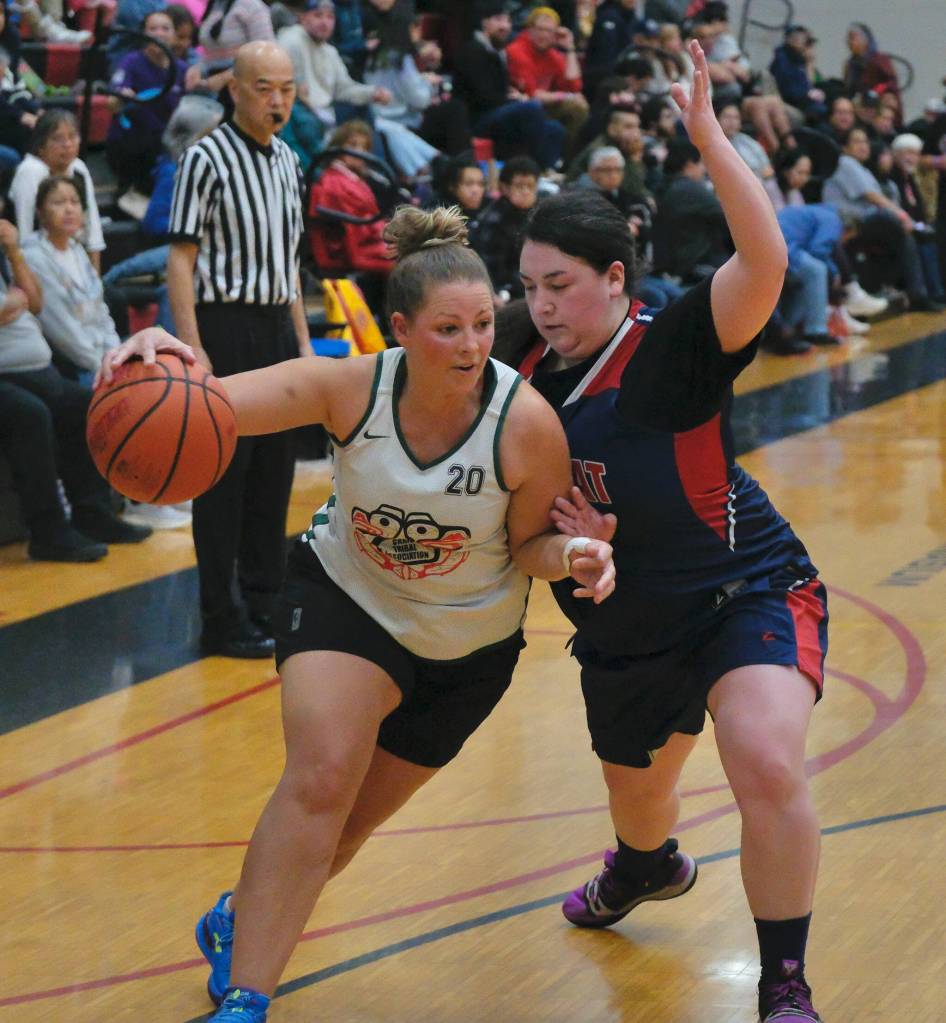 Craigs Molly Sharp drives against Yakutats Nadine Fraker during Craigs 53-41 Womens Bracket win Monday at the 76th Annual Juneau Lions Club Gold Medal Basketball Tournament in Juneau-Douglas High School: Yadaa.at Kalés George Houston Gymnasium. (Klas Stolpe / Juneau Empire)