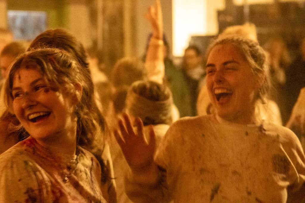 Bella Sanders and Tatum Hartlieb laugh after the throwing of colors on Monday, March 24, 2025. (Jasz Garrett / Juneau Empire)