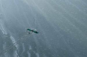 The three survivors of a Sunday afternoon plane crash are found atop the wing of their plane near Tustumena Lake in Kasilof on Monday, March 24, 2025. (Photo by Dale Eicher)