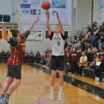 Juneau AMLs Caleb Tompkins (4) scores over Mt. Edgecumbes Zach Ancerson during Juneaus 91-67 A Bracket win Tuesday at the 76th Annual Juneau Lions Club Gold Medal Basketball Tournament in Juneau-Douglas High School: Yadaa.at Kalés George Houston Gymnasium. (Klas Stolpe / Juneau Empire)