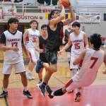 Hydaburgs Claude Young is charged with an offensive foul on Yakutats Christian Adams (7) during their 83-61 B Bracket win over Yakutat Tuesday at the 76th Annual Juneau Lions Club Gold Medal Basketball Tournament in Juneau-Douglas High School: Yadaa.at Kalés George Houston Gymnasium. (Klas Stolpe / Juneau Empire)