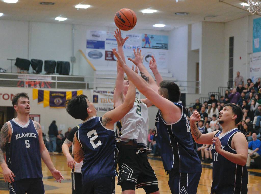 Ketchikans Clayton Olmstead (2) puts up a last second shot among Klawock defenders Nate Yockey (5), Emett Fairbanks (2) Tyler Coleman and Trae Marvin (11) to win a B Bracket elimination game 89-87 Tuesday at the 76th Annual Juneau Lions Club Gold Medal Basketball Tournament in Juneau-Douglas High School: Yadaa.at Kalés George Houston Gymnasium. (Klas Stolpe / Juneau Empire)
