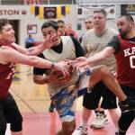 Metlakatlas Willie Hayward secures rebound under pressure from Kakes Jess Ross and Anthony Ross (00) during Kakes 62-48 Masters Bracket win Tuesday at the 76th Annual Juneau Lions Club Gold Medal Basketball Tournament in Juneau-Douglas High School: Yadaa.at Kalés George Houston Gymnasium. (Klas Stolpe / Juneau Empire)