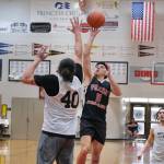 Filcoms Alwen Carrillo (11) floats a shot over Southeast Boys Ryan Lee (40) during Filcoms 77-74 A Bracket win Tuesday at the 76th Annual Juneau Lions Club Gold Medal Basketball Tournament in Juneau-Douglas High School: Yadaa.at Kalés George Houston Gymnasium. (Klas Stolpe / Juneau Empire)