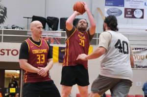 Mt. Edgecumbes Zach Anderson (50) scores on a screen by Brian Friske (33) as Southeast Boys Ryan Lee (40) closes out during Mt. Edgecumbes 81-55 A Bracket elimination game win Wednesday at the 76th Annual Juneau Lions Club Gold Medal Basketball Tournament in Juneau-Douglas High School: Yadaa.at Kalés George Houston Gymnasium. (Klas Stolpe / Juneau Empire)
