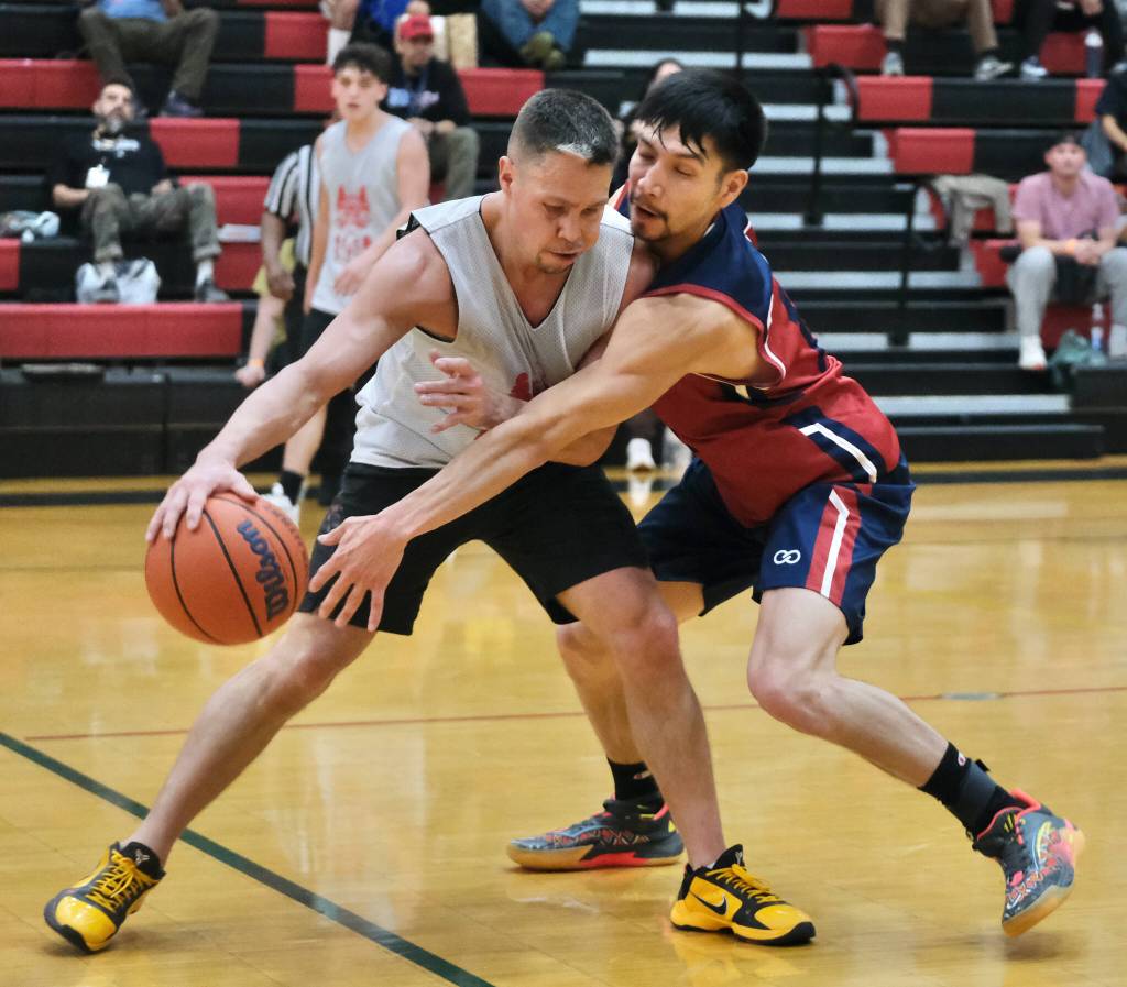 Hydaburgs Vinny Edenshaw protects the ball under pressure from Kakes Simon Friday during Hydaburgs 70-47 B Bracket elimination game win Wednesday at the 76th Annual Juneau Lions Club Gold Medal Basketball Tournament in Juneau-Douglas High School: Yadaa.at Kalés George Houston Gymnasium. (Klas Stolpe / Juneau Empire)