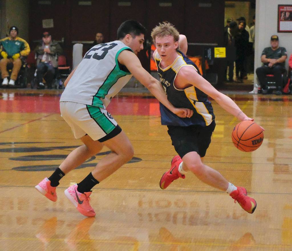 Ketchikans Clayton Olmstead (2) gets around Haines Kirby Faverty (23) during Haines 91-51 B Bracket elimination game win Wednesday at the 76th Annual Juneau Lions Club Gold Medal Basketball Tournament in Juneau-Douglas High School: Yadaa.at Kalés George Houston Gymnasium. (Klas Stolpe / Juneau Empire)