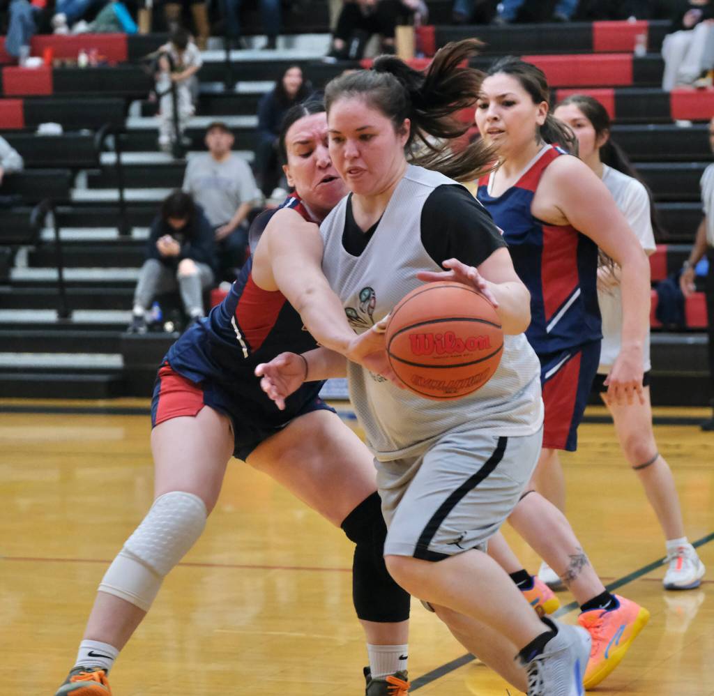 Yakutats Lorena Williams attempts to steal a ball from Angoons Roxann Braley during Yakutats 79-30 Womens Bracket elimination game win Wednesday at the 76th Annual Juneau Lions Club Gold Medal Basketball Tournament in Juneau-Douglas High School: Yadaa.at Kalés George Houston Gymnasium. (Klas Stolpe / Juneau Empire)
