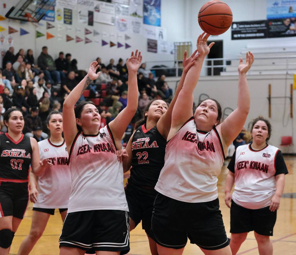 Hoonahs Antonia Fogg (22) battles for a rebound with Kakes Heather Gatti and Miakah Nix during Hoonahs 60-41 Womens Bracket elimination game win Wednesday at the 76th Annual Juneau Lions Club Gold Medal Basketball Tournament in Juneau-Douglas High School: Yadaa.at Kalés George Houston Gymnasium. (Klas Stolpe / Juneau Empire)