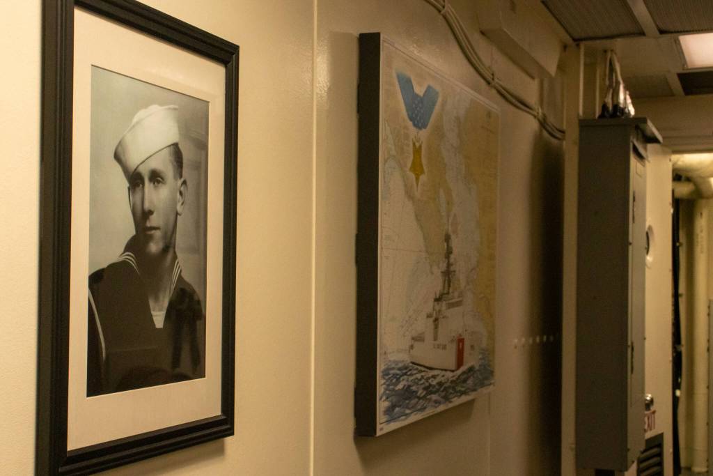 A portrait of Douglas A. Munro is seen in the hall leading to the captains cabin on the U.S. Coast Guard Cutter Munro on Tuesday, March 25, 2025. Beside his portrait is a chart of Munros homeport in San Francisco Bay. In the upper left-hand corner of that chart is the Congressional Medal of Honor, which Munro was awarded after he was killed in action in September 1942. (Jasz Garrett / Juneau Empire)