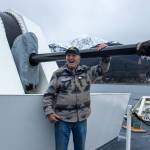 Tom Dawson touches a 57-millimeter Bofors gun during a tour of the U.S. Coast Guard Cutter Munro on Tuesday, March 25, 2025. (Jasz Garrett / Juneau Empire)