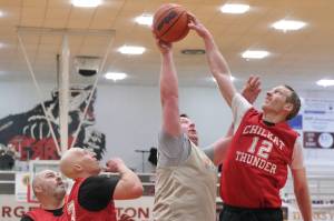 Klukwans Andrew Friske (12) blocks a shot by Metlakatlas Danny Marsden as Klukwans Stuart Dewitt and Brian Friske look on during their 65-63 Masters Bracket elimination game win over Metlakatla on Thursday at the 76th Annual Juneau Lions Club Gold Medal Basketball Tournament in Juneau-Douglas High School: Yadaa.at Kalés George Houston Gymnasium. (Klas Stolpe / Juneau Empire)
