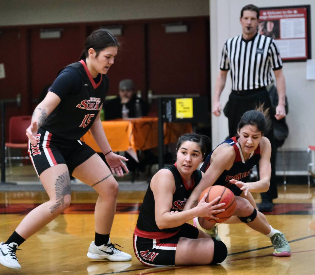 Hoonahs Alona Howland (15) and Melissa Fisher and Yakutats Trinity Jackson battle for a loose ball during Yakutats 67-50 Womens Bracket elimination game win over Hoonah Thursday at the 76th Annual Juneau Lions Club Gold Medal Basketball Tournament in Juneau-Douglas High School: Yadaa.at Kalés George Houston Gymnasium. (Klas Stolpe / Juneau Empire)