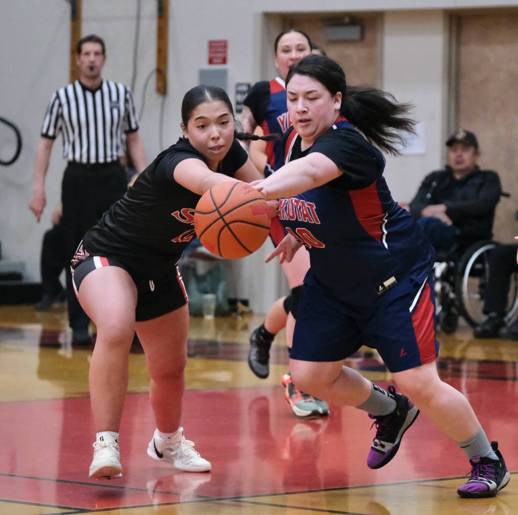 Hoonahs Larissa Dubdahl (12) and Yakutats Nadine Fraker (10) go for a ball during Yakutats 67-50 Womens Bracket elimination game win over Hoonah Thursday at the 76th Annual Juneau Lions Club Gold Medal Basketball Tournament in Juneau-Douglas High School: Yadaa.at Kalés George Houston Gymnasium. (Klas Stolpe / Juneau Empire)