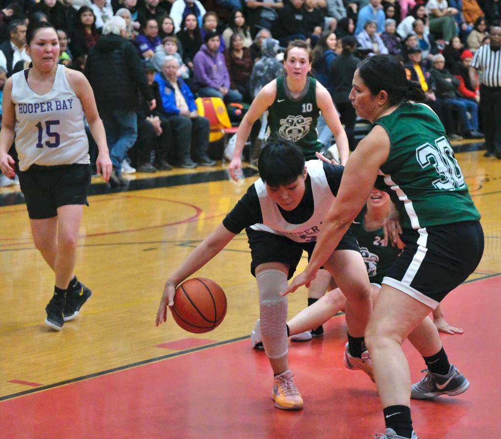 Craigs Tina Steffen defends Hooper Bays Susie Long during Craigs 70-49 Womens Bracket semifinal win Thursday at the 76th Annual Juneau Lions Club Gold Medal Basketball Tournament in Juneau-Douglas High School: Yadaa.at Kalés George Houston Gymnasium. (Klas Stolpe / Juneau Empire)