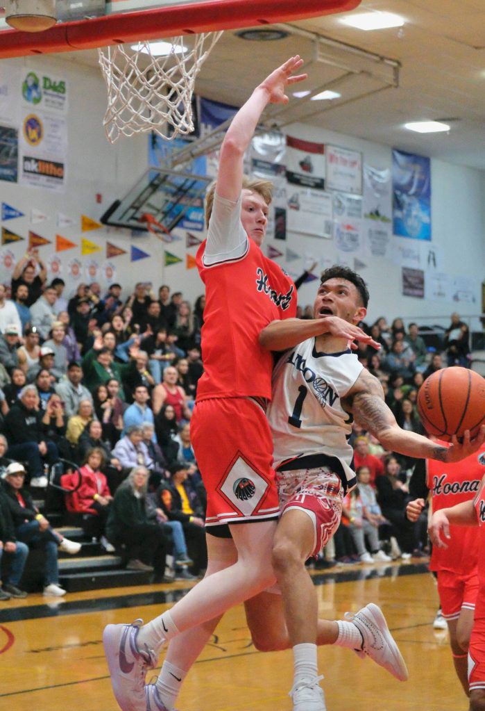 Angoons Aquino Brinson (1) shoots against Hoonahs Sean Oliver during Angoons 89-70 C Bracket semifinal win Thursday at the 76th Annual Juneau Lions Club Gold Medal Basketball Tournament in Juneau-Douglas High School: Yadaa.at Kalés George Houston Gymnasium. (Klas Stolpe / Juneau Empire)