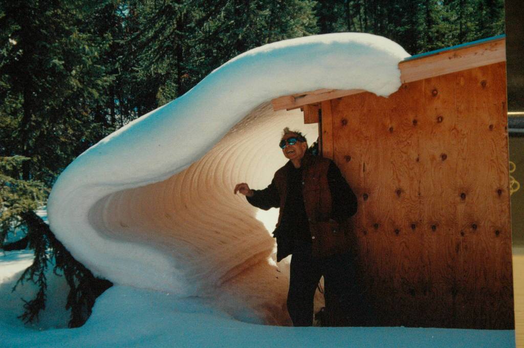 The late Bill Fuller of Fairbanks poses by a deforming snow formation near his shed in Fairbanks in the 1990s. (Photo by John Lyle)