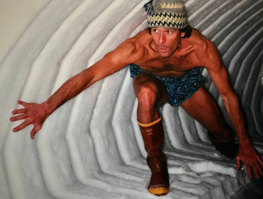 John Lyle, formerly of Fairbanks and now of Hawaii, surfs a snow formation that curled off a neighbors shed during a spring in the 1990s. (Photo courtesy John Lyle)