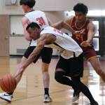 Filcoms Tony Yadao runs Mt. Edgecumbe defender Tyrell Cromer through a screen by Garrett Bryant (31) during Mt. Edgecumbes 86-79 A Bracket elimination game win Friday at the 76th Annual Juneau Lions Club Gold Medal Basketball Tournament in Juneau-Douglas High School: Yadaa.at Kalés George Houston Gymnasium. (Klas Stolpe / Juneau Empire)
