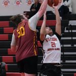Mt. Edgecumbes Zach Anderson (50) blocks a shot by Filcoms Jhowel Estigoy (21) during Mt. Edgecumbes 86-79 A Bracket elimination game win Friday at the 76th Annual Juneau Lions Club Gold Medal Basketball Tournament in Juneau-Douglas High School: Yadaa.at Kalés George Houston Gymnasium. (Klas Stolpe / Juneau Empire)
