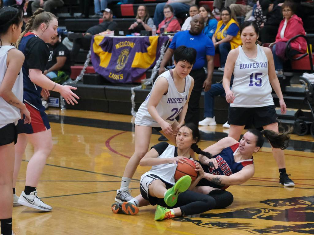 Hooper Bays Ernie Joe and Yakutats Lorena Williams battle for a loose ball Friday during Hooper Bays 60-58 Womens Bracket elimination game win over Yakutat at the 76th Annual Juneau Lions Club Gold Medal Basketball Tournament in Juneau-Douglas High School: Yadaa.at Kalés George Houston Gymnasium. (Klas Stolpe / Juneau Empire)