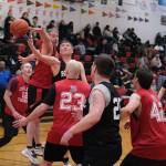 Kakes Lloyd Davis scoops a shot under pressure from Klukwans Dave Buss and Brian Friske (23) during Klukwans 75-43 Masters Bracket elimination game win over Kake at the 76th Annual Juneau Lions Club Gold Medal Basketball Tournament in Juneau-Douglas High School: Yadaa.at Kalés George Houston Gymnasium. (Klas Stolpe / Juneau Empire)
